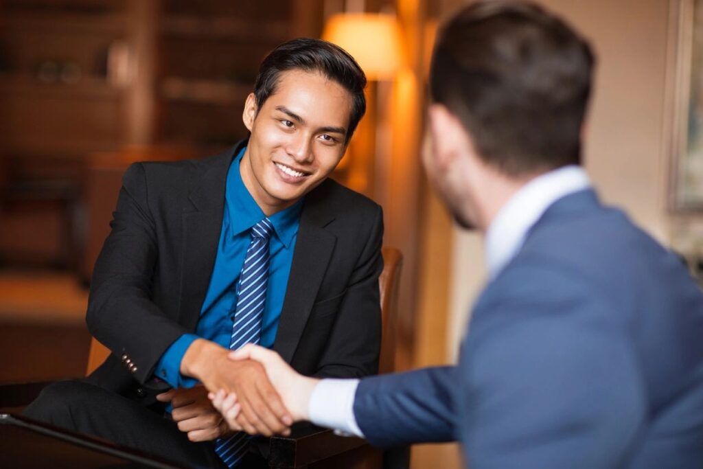 Two men shaking hands wearing suits